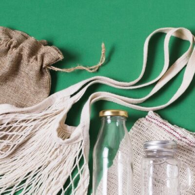 top-view-different-zero-waste-products-green-background_- corporate promotional gifts