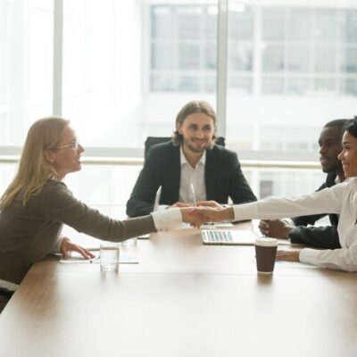 diverse-smiling-businesswomen-shaking-hands-greeting-multiracial-group-meeting_- CORPORATE GIFTS UAE