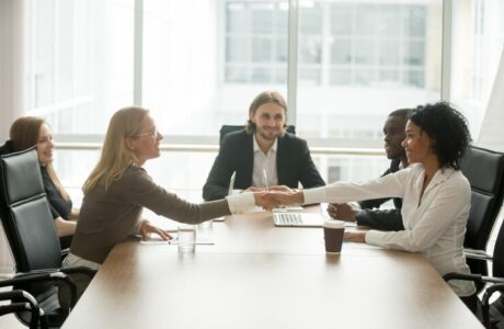 diverse-smiling-businesswomen-shaking-hands-greeting-multiracial-group-meeting_- CORPORATE GIFTS UAE