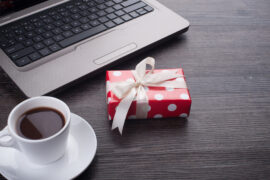 Laptop computer with cup of tea and gift box corporate gifts qatar corporate gifts oman