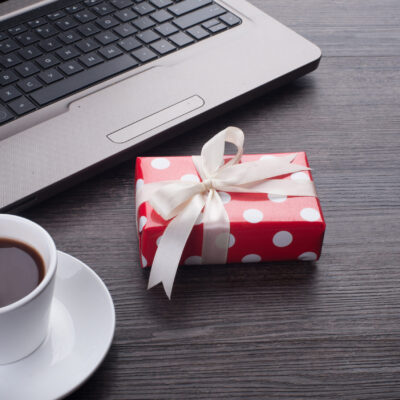 Laptop computer with cup of tea and gift box corporate gifts qatar corporate gifts oman