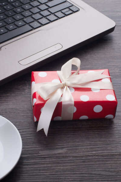 Laptop computer with cup of tea and gift box corporate gifts qatar corporate gifts oman