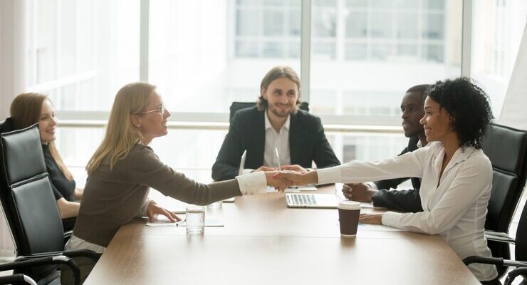 diverse-smiling-businesswomen-shaking-hands-greeting-multiracial-group-meeting_- CORPORATE GIFTS UAE