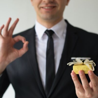 close-up-happy-businessman-holding-small-gift-box_-