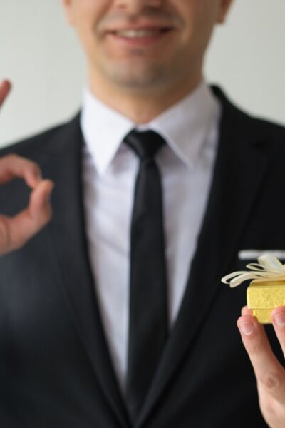 close-up-happy-businessman-holding-small-gift-box_-