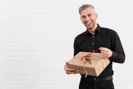 man-black-suit-unwrapping-gift-smiles_-
