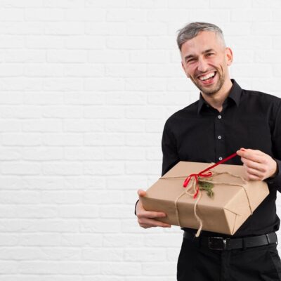 man-black-suit-unwrapping-gift-smiles_-