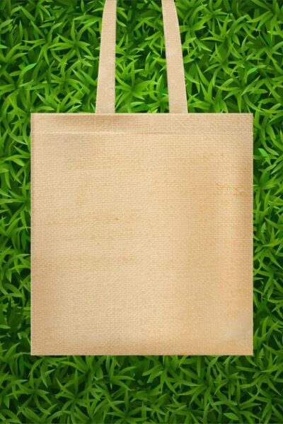 realistic-hands-bag-green-grass-composition_-
