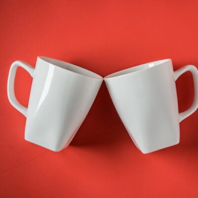 top-view-two-white-ceramic-coffee-cups-red_-