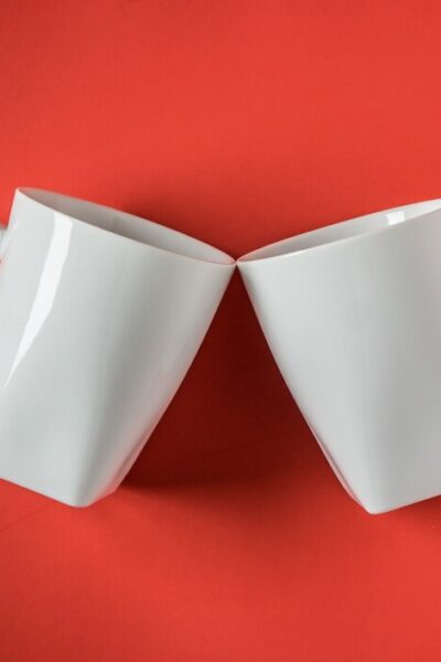 top-view-two-white-ceramic-coffee-cups-red_-