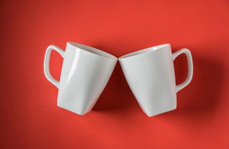 top-view-two-white-ceramic-coffee-cups-red_-