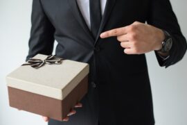 unrecognizable-businessman-holding-brown-gift-box_-
