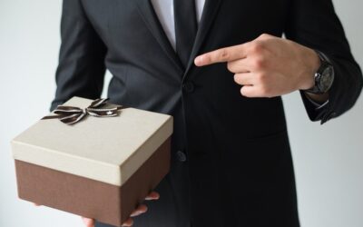 unrecognizable-businessman-holding-brown-gift-box_-