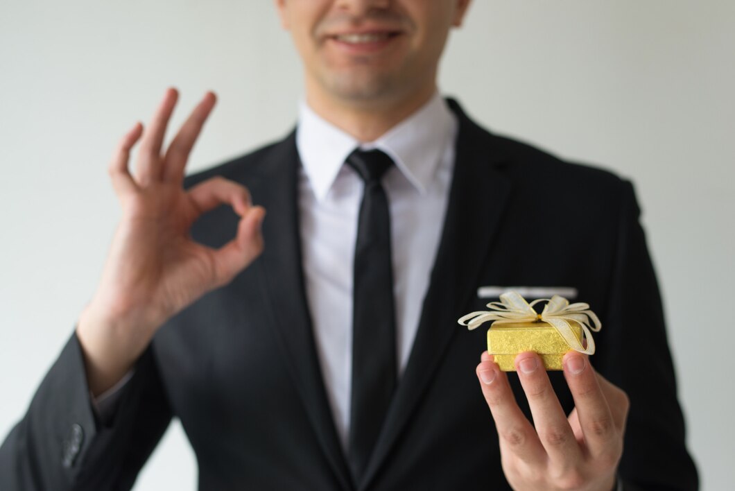 close-up-happy-businessman-holding-small-gift-box_-