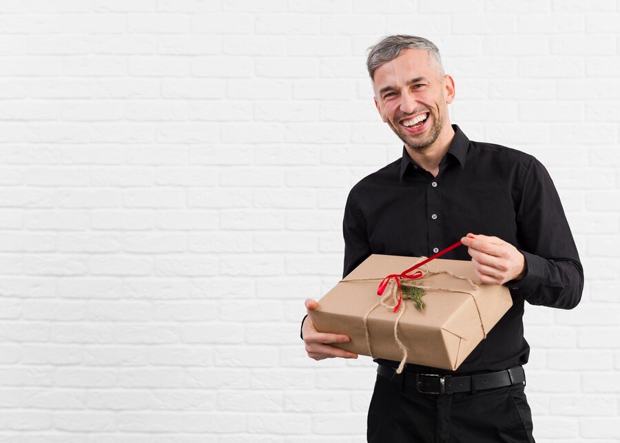 man-black-suit-unwrapping-gift-smiles_-
