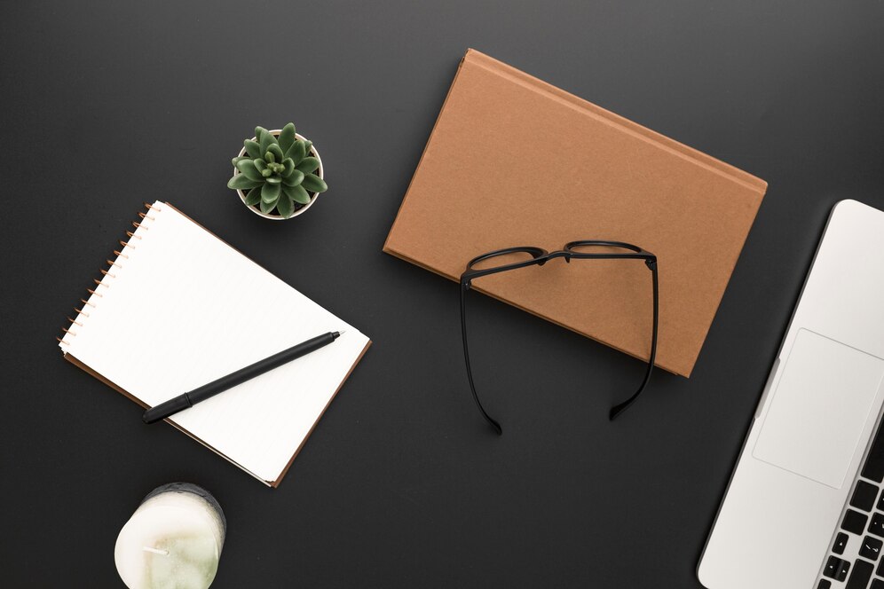 top-view-workspace-with-glasses-laptop_-